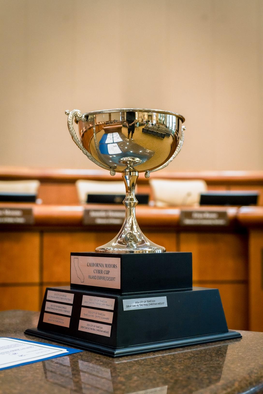 The IE Mayors Cyber Cup perpetual trophy with 7 years of winners